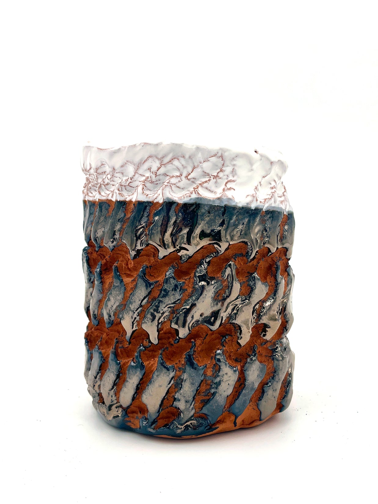 Side view of the Ceramic Pot Candle, with deep-red clay and platinum glaze, highlighting hyper-textured handcrafted details from the Textile Print Series