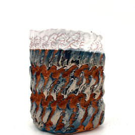 Side view of the Ceramic Pot Candle, with deep-red clay and platinum glaze, highlighting hyper-textured handcrafted details from the Textile Print Series