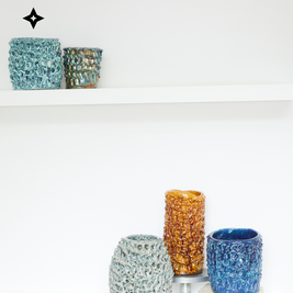 Composition of five Ceramic Vases in different colors, arranged at varying heights on a white background, highlighting the variety and craftsmanship of the collection and the harmony within pieces.