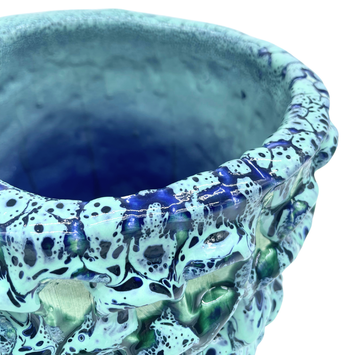 Side view of the Ceramic Vase in Aqua and Saltwater Blue from the upper angle, highlighting the tactile surface and distinctive wave-like texture.
