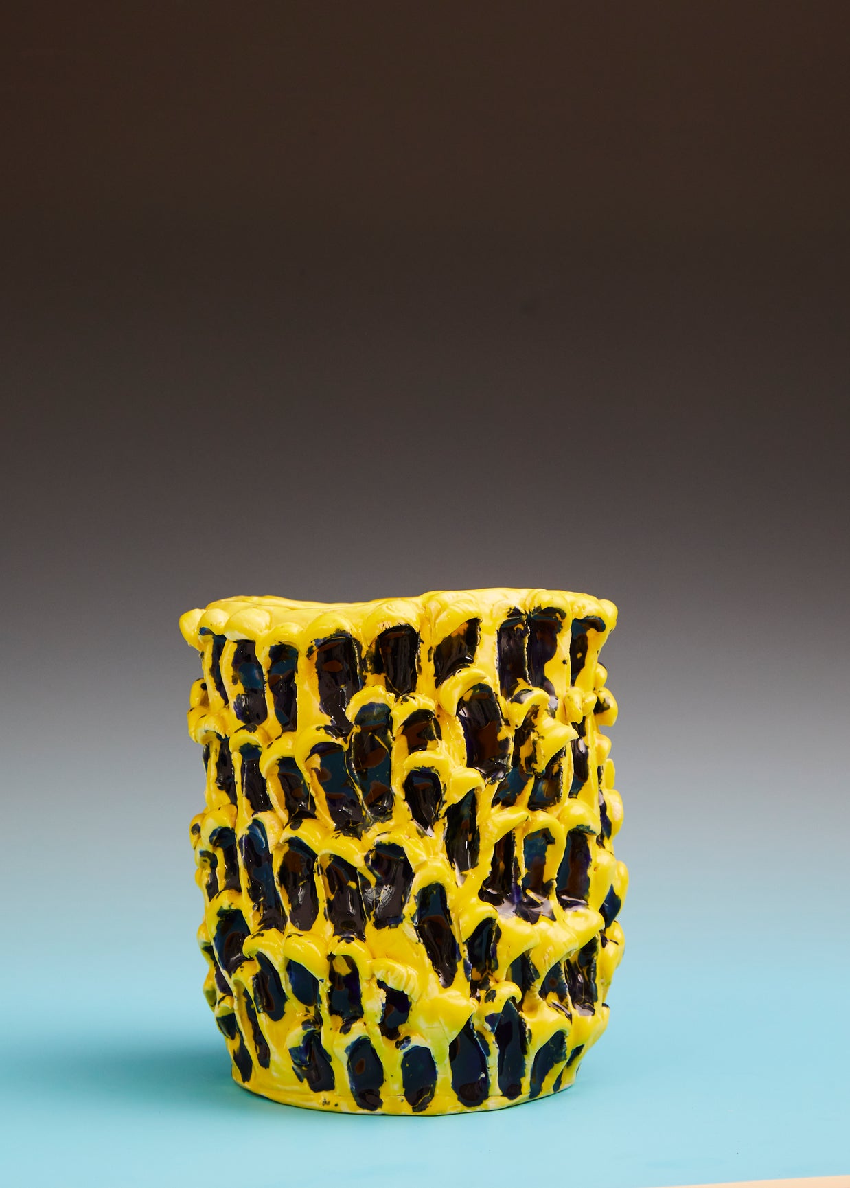 Front view of the Ceramic Vase in Cadmium Yellow and Izmir Blue with a soft gradient background, highlighting its smooth texture and bold colors in contrast to the surface.