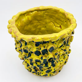 Upper side view of the Ceramic Vase in Cadmium Yellow and Izmir Blue, highlighting the wave-like texture and smooth gradient of colors on a white background.