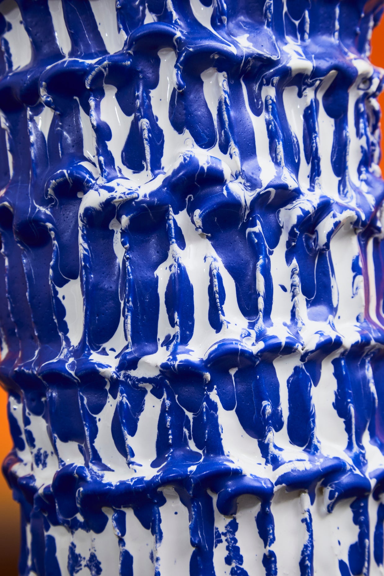Medium detail of the Ceramic Vase in Egyptian Blue and White, showcasing the intricate wave-like textures and rich glaze application, with white and blue lines of colour.