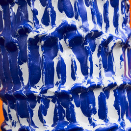 Medium detail of the Ceramic Vase in Egyptian Blue and White, showcasing the intricate wave-like textures and rich glaze application, with white and blue lines of colour.