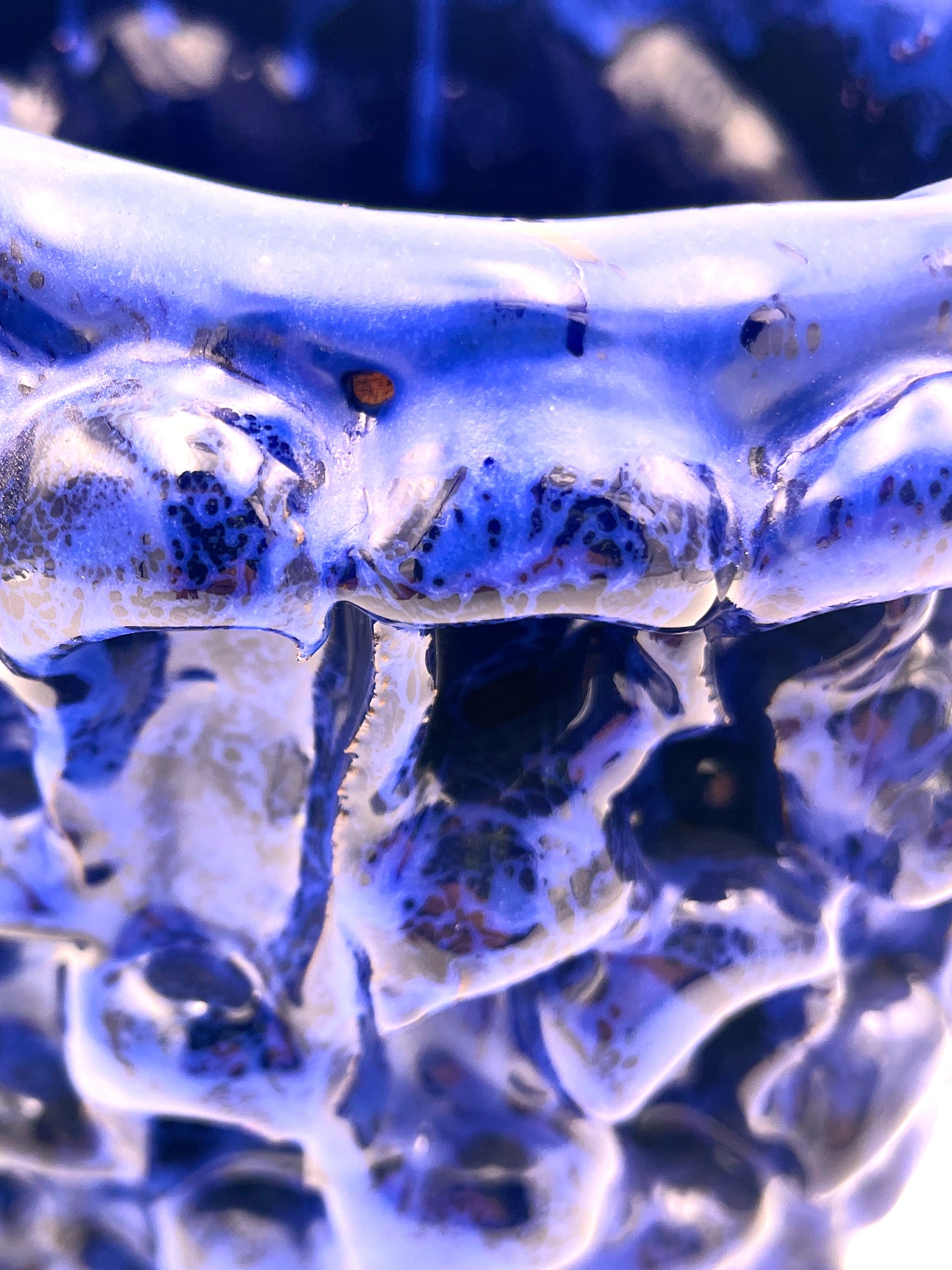 Close-up of the upper edge of the Ceramic Vase in Egyptian and Izmir Blue, capturing the intricate wave texture and glossy glaze with blue and brown shades.