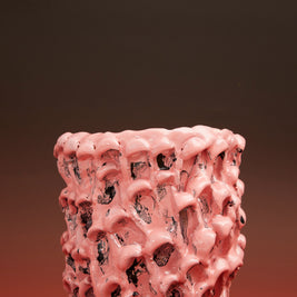 Front view of the Ceramic Vase in Haime Pink and Liquorice, set against a gradient background of brick and light black, enhancing its bold color palette.