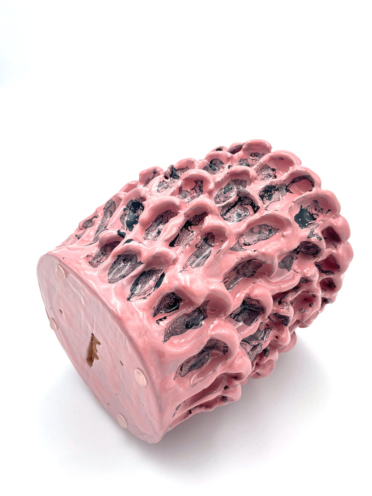 Ceramic Vase in Haime Pink and Liquorice positioned horizontally, highlighting its curved shape and glossy finish and uniform base.