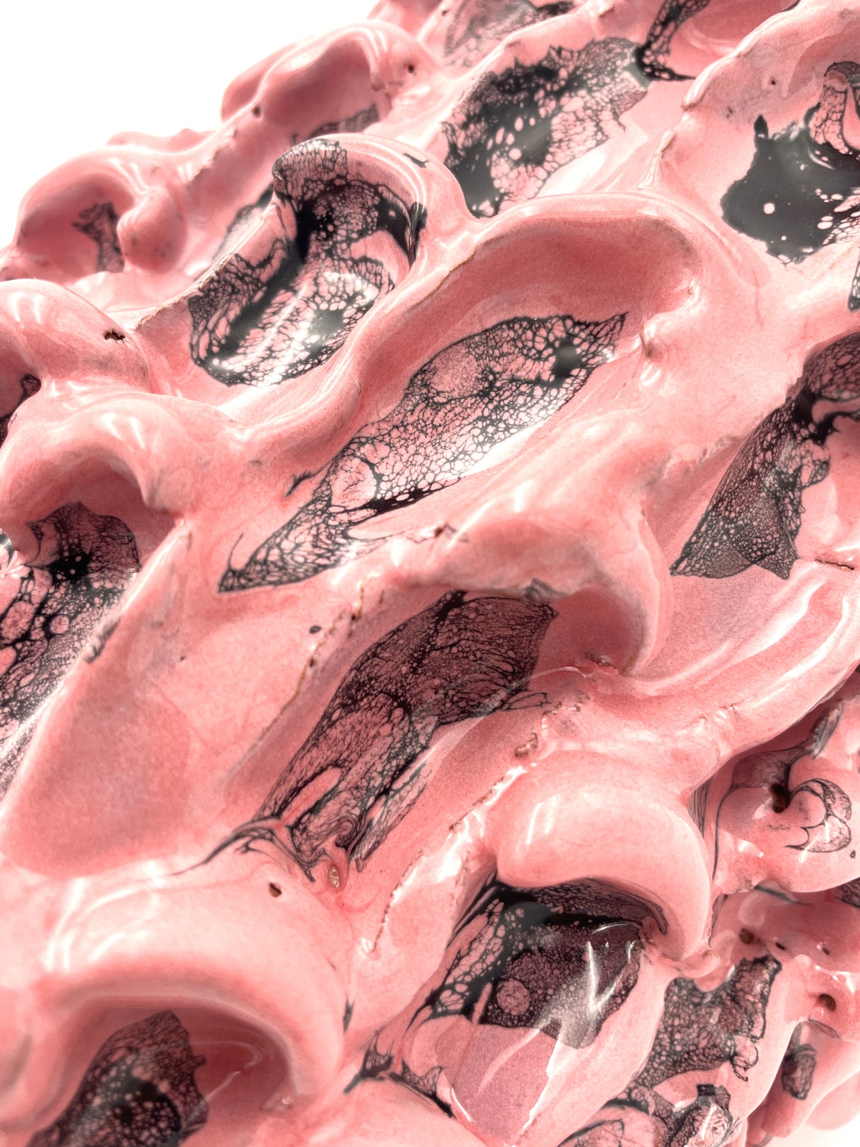 Detailed perspective of the Ceramic Vase in Haime Pink and Liquorice, focusing on the subtle textures and rich glaze application, with a net texture of the liquorice tonesover the pink ones.