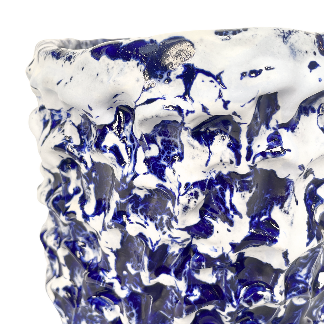 Close-up detail of the top of the Ceramic Vase in Izmir Blue and Matte White, where the edge is mostly uniform white with a few white drops on the blue.