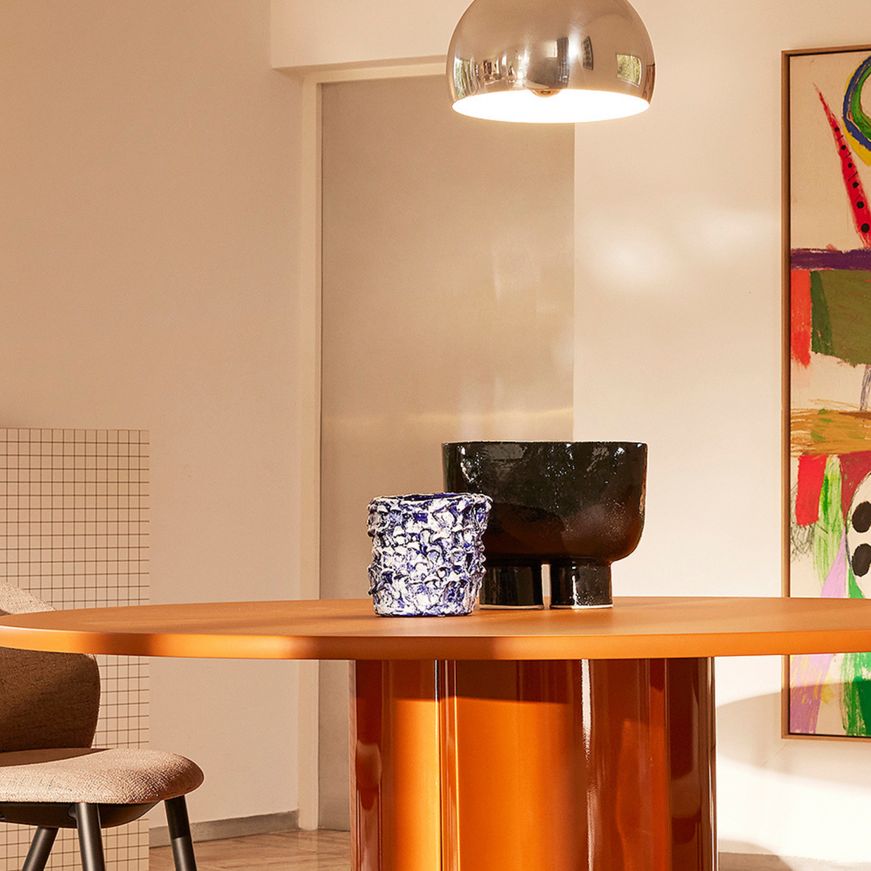Living room composition with the Ceramic Vase in Izmir Blue and Matte White placed on a wooden table, surrounded by neutral furniture, a light wall.