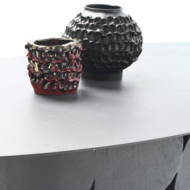 Two Ceramic Vases in Licorice Black displayed on a white table against a white wall, highlighting their distinct shapes and colours, and minimalist aesthetic.