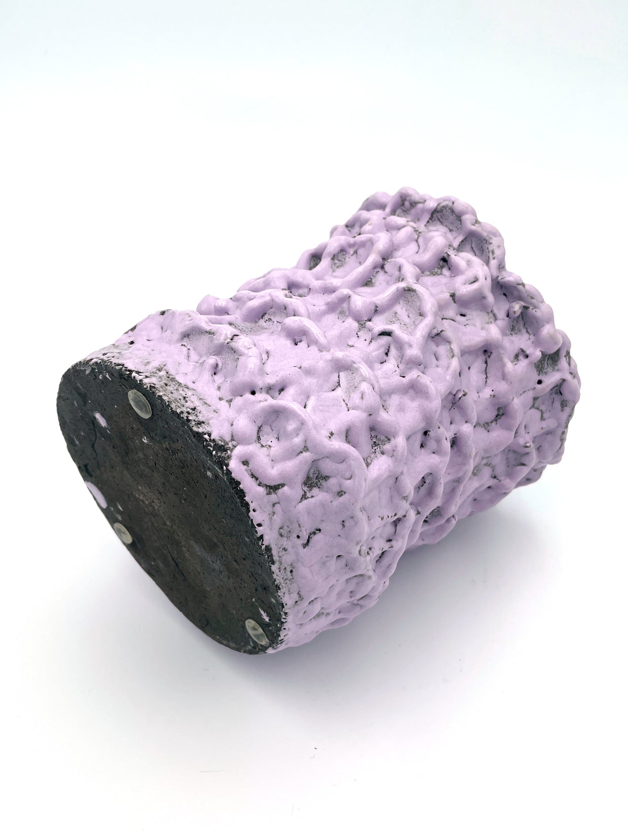 Horizontal view of the Ceramic Vase in Lilac Bubble & Chocolate, showcasing its textured pink and black surface, set on a white background.