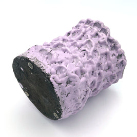 Horizontal view of the Ceramic Vase in Lilac Bubble & Chocolate, showcasing its textured pink and black surface, set on a white background.