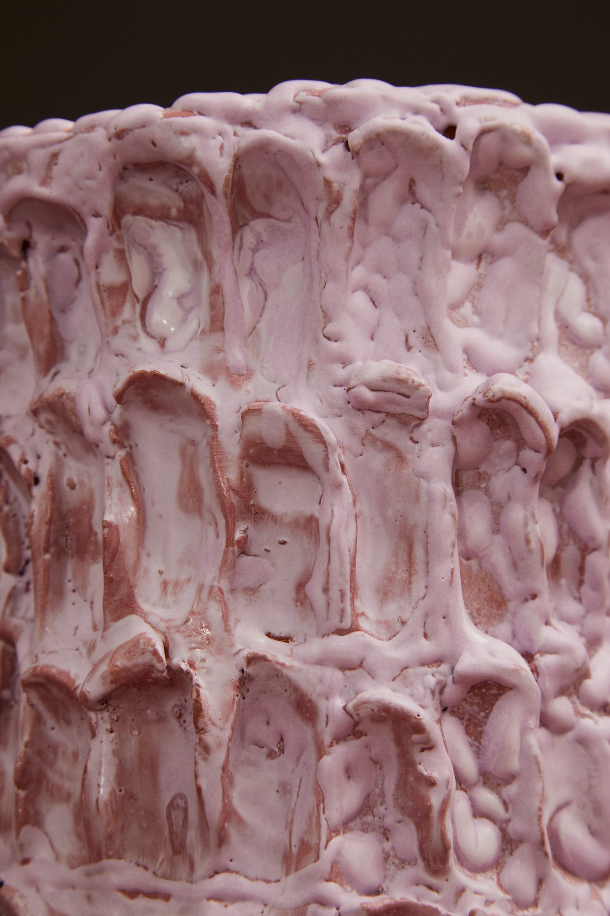 Close-up of the Ceramic Vase in Lilac Bubble & Matte Mauve, with its pink and peachy tones contrasted against a dramatic black background.