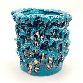 Front view from a slightly different angle of the Ceramic Vase in Metallic Biscay Bay, emphasizing the dynamic interplay of its petrol blue, black, and golden hues.