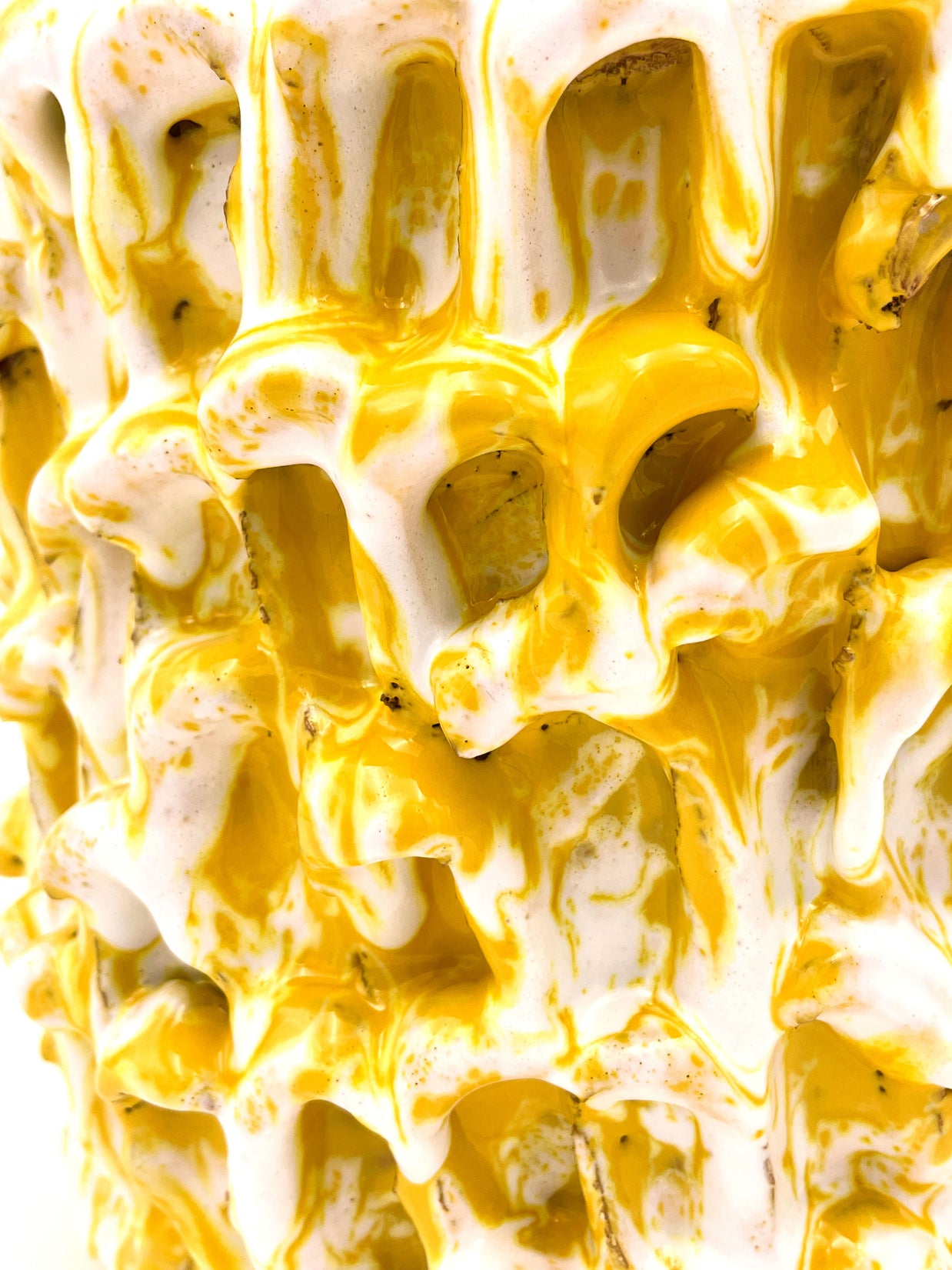 Close-up of the Ceramic Vase in Metallic Mineral Blush, highlighting the interplay of yellow and white in its textured surface.