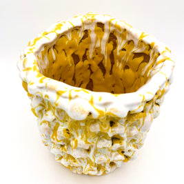 Top diagonal view of the Ceramic Vase in Metallic Mineral Blush, offering a glimpse of the interior and its intricate yellow and white texture with some neutral inserts.