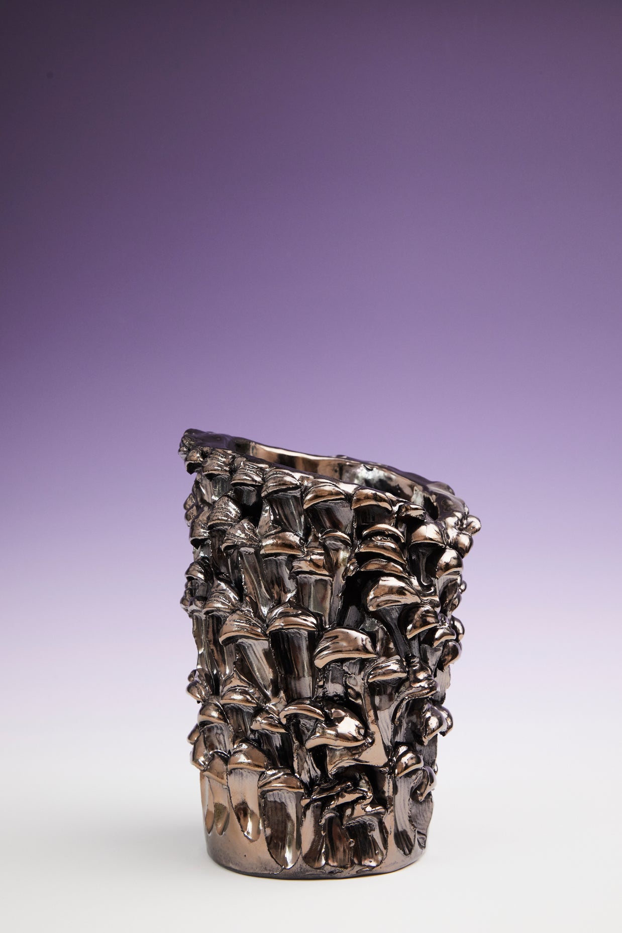 Front view of the Ceramic Vase in Metallic Platinum, set against a gradient background transitioning from white at the bottom to violet at the top.