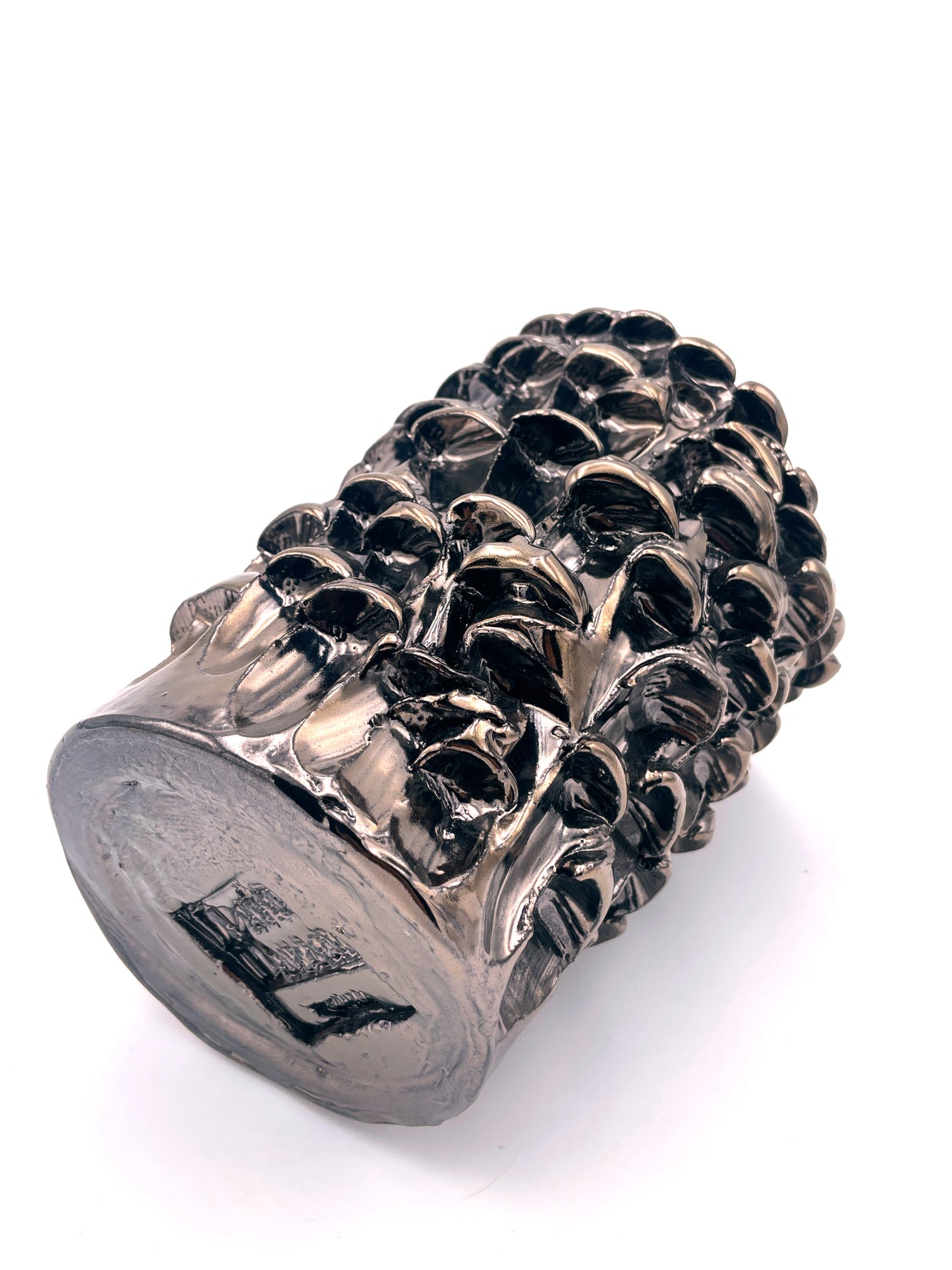 Horizontal view of the Ceramic Vase in Metallic Platinum, showing the intricate harmonious surface and the artist's signature on the uniformly textured base.