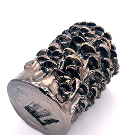 Horizontal view of the Ceramic Vase in Metallic Platinum, showing the intricate harmonious surface and the artist's signature on the uniformly textured base.