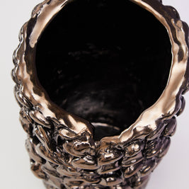 Top view of the Ceramic Vase in Metallic Platinum, capturing the warm coppery reflection on its surface under specific lighting.
