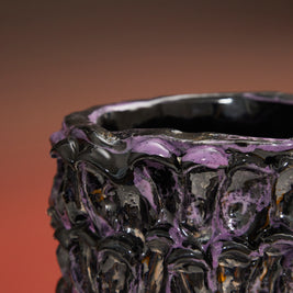 Close-up detail of the Ceramic Vase in Metallic Purple with a gradient backdrop transitioning from deep red to black.