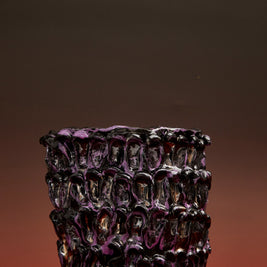 Front view of the Ceramic Vase in Metallic Purple against a gradient background transitioning from deep red at the base to black at the top.