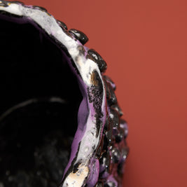 Top-side border view of the Ceramic Vase in Metallic Purple, highlighting its reflective metallic surface against a gradient background.