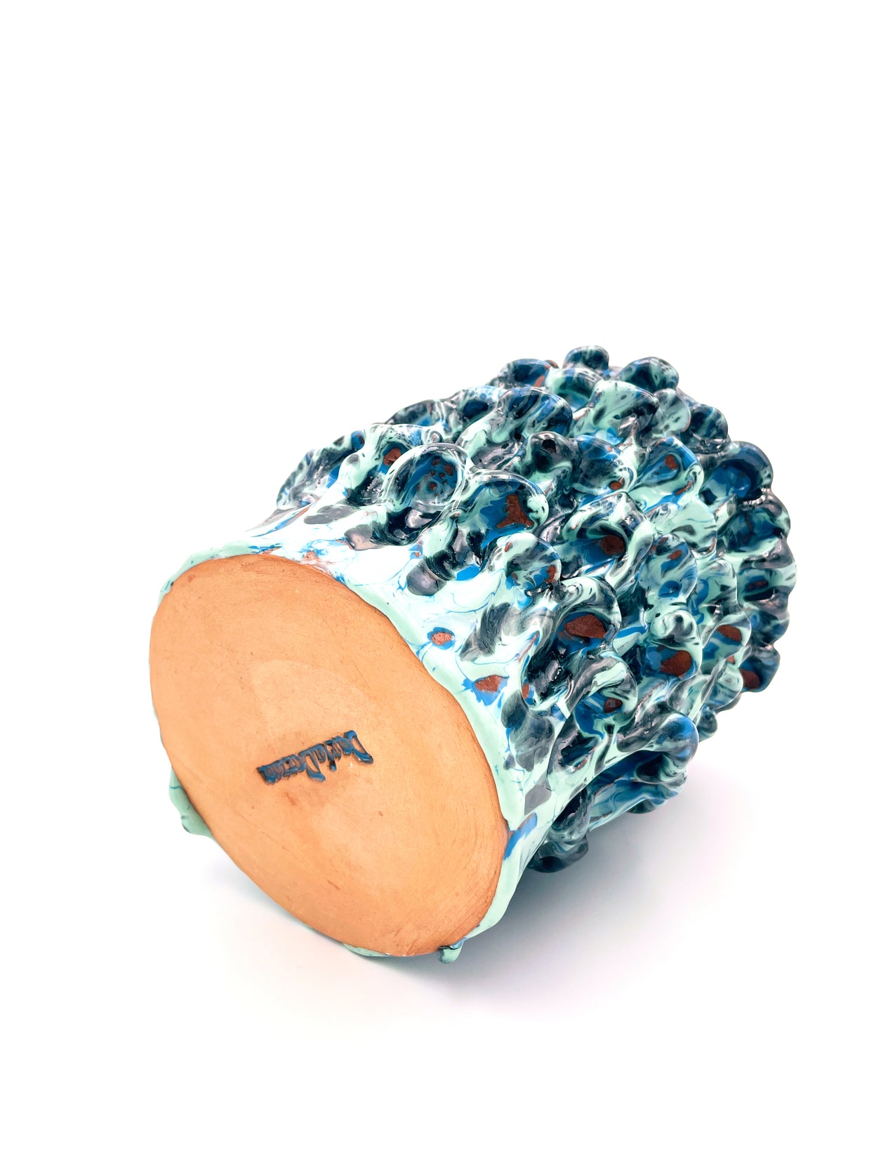Bottom view of the Ceramic Vase in Metallic Tiffany and Turquoise, showing the artist's signature and the smooth uniform texture of the base.