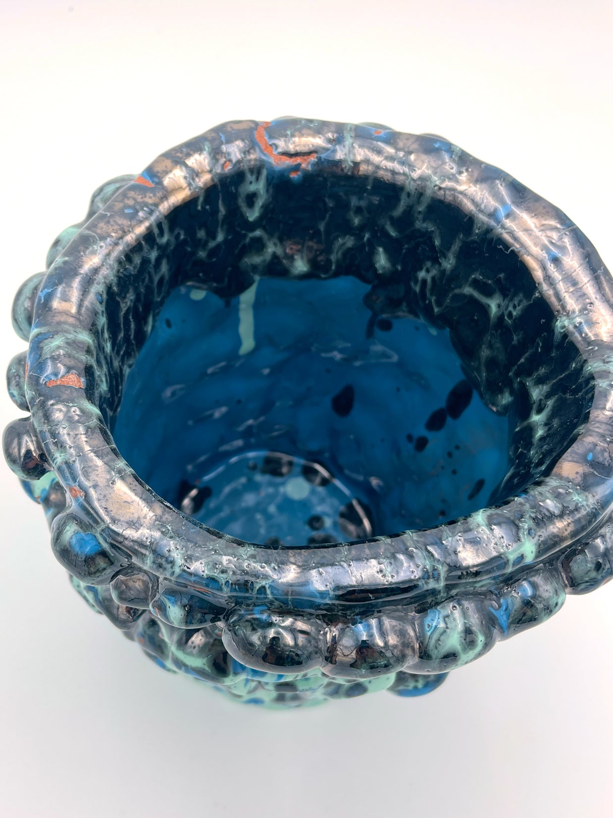 Close-up top view of the Ceramic Vase in Metallic Tiffany and Turquoise, displaying its bicolored interior with light turquoise at the base, darker tones near the rim, and hints of reddish-bronze accents.