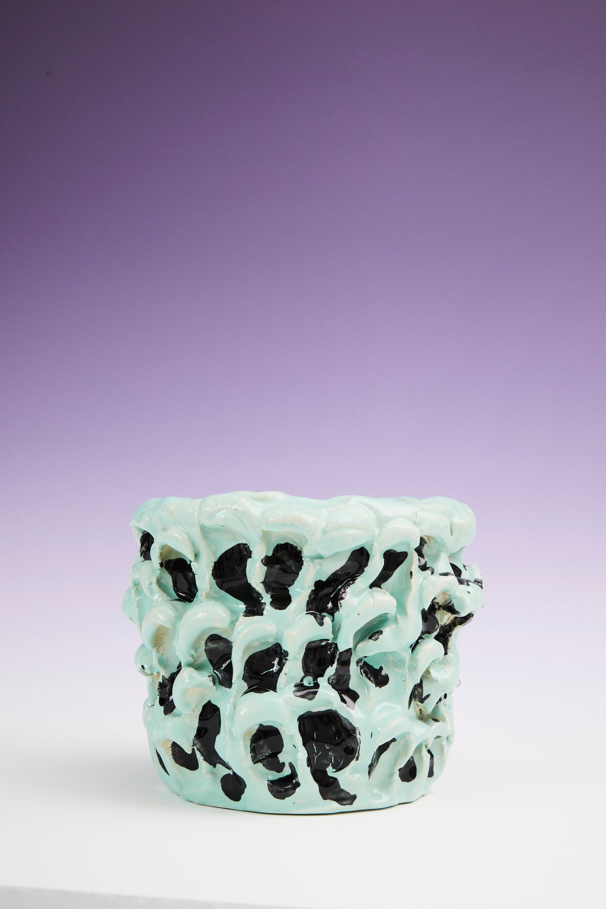 Zoomed-out front view of the Ceramic Vase in Tiffany and Pitch Black, with a stunning gradient background transitioning from purple at the top to white at the bottom, emphasizing the vase's unique design.