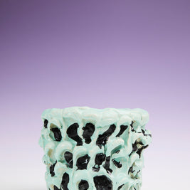 Zoomed-out front view of the Ceramic Vase in Tiffany and Pitch Black, with a stunning gradient background transitioning from purple at the top to white at the bottom, emphasizing the vase's unique design.
