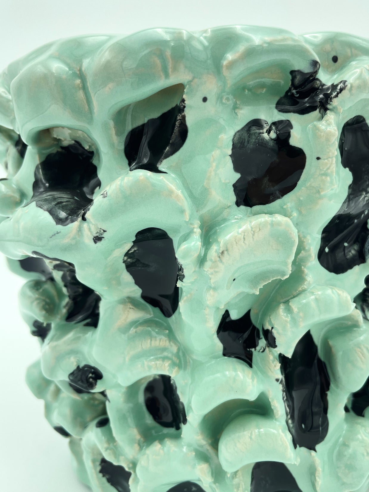 Close-up view of the texture on the Ceramic Vase in Tiffany and Pitch Black, highlighting the wave patterns and black inserts, with a clean white background.