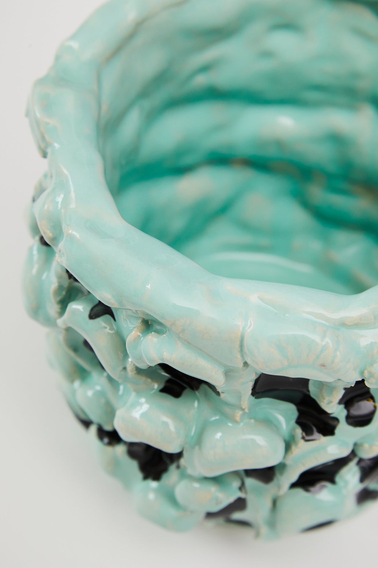 Close-up detail of the upper side of the Ceramic Vase in Tiffany and Pitch Black, focusing on the hand-formed waves and color contrast against a white background.