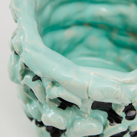 Close-up detail of the upper side of the Ceramic Vase in Tiffany and Pitch Black, focusing on the hand-formed waves and color contrast against a white background.