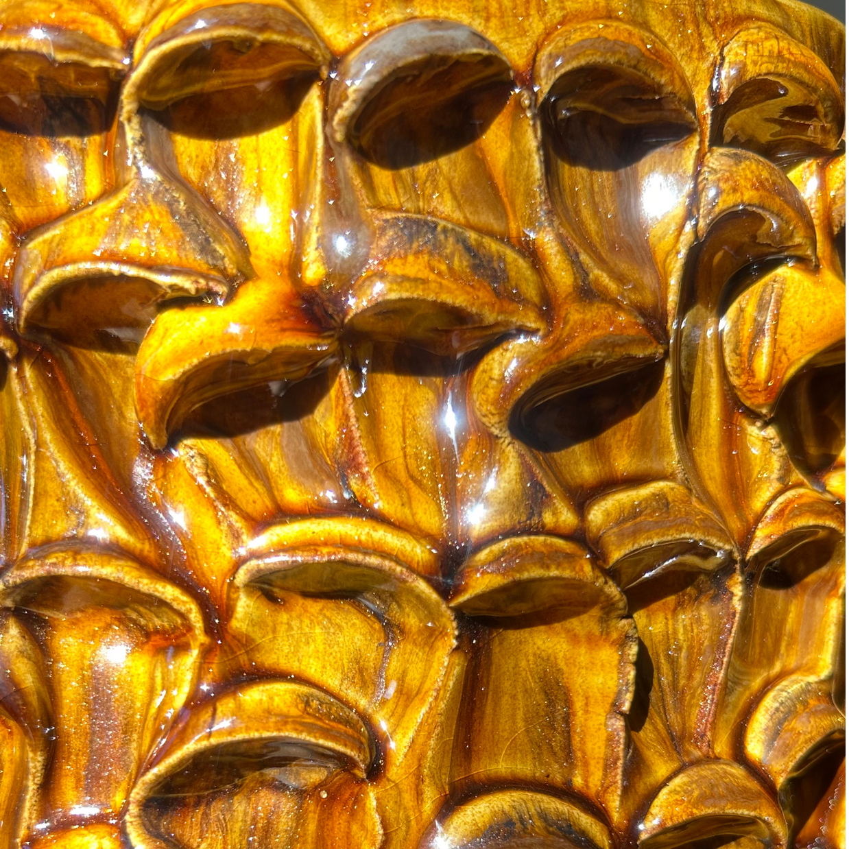Close-up view of the textured surface of the Ceramic Vase in Translucent Honey, showcasing the masterful color application and wave design.