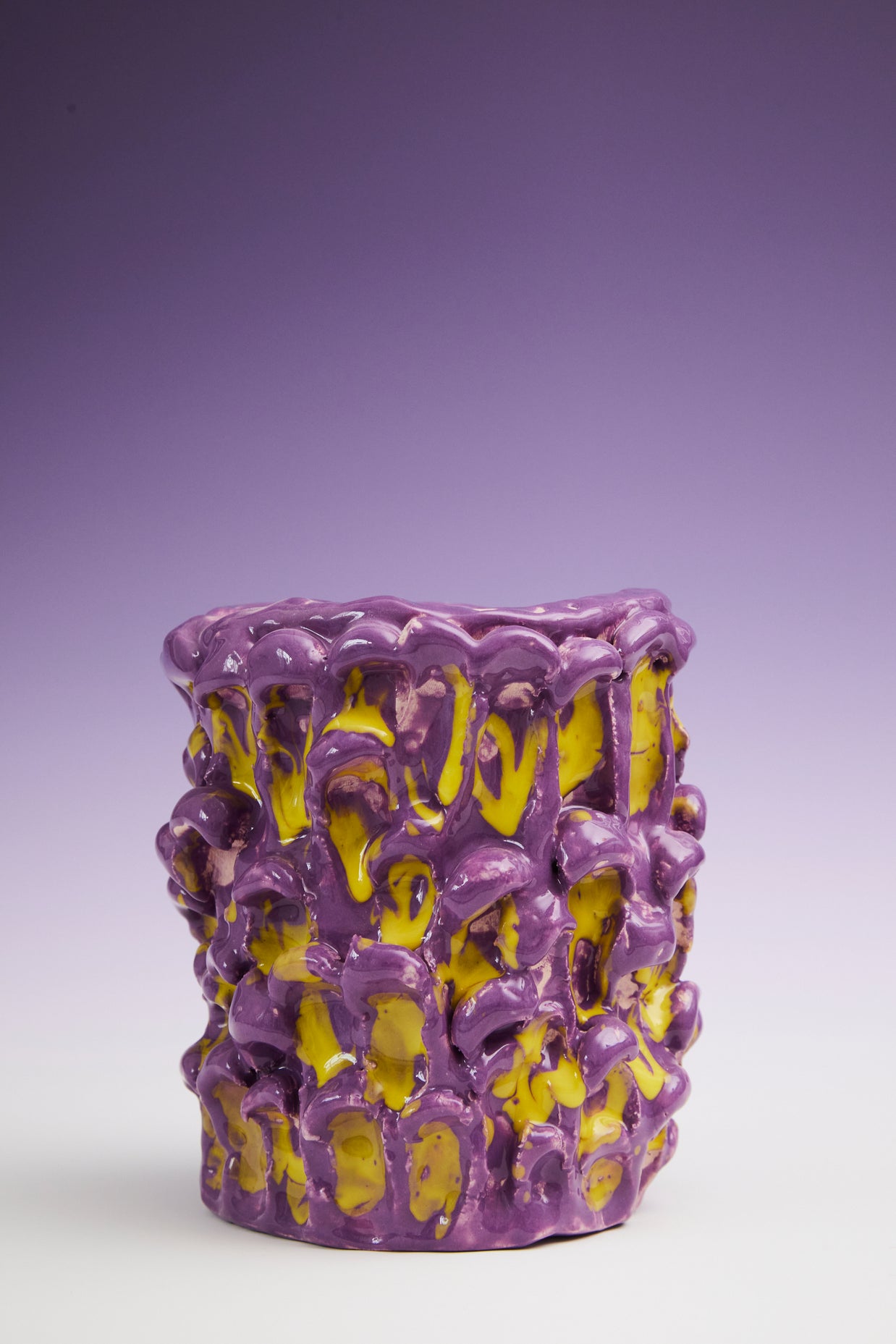 Front view of the Ceramic Vase in Velvet Purple and Lemon Yellow, placed against a gradient background transitioning from deep violet at the top to white at the bottom.