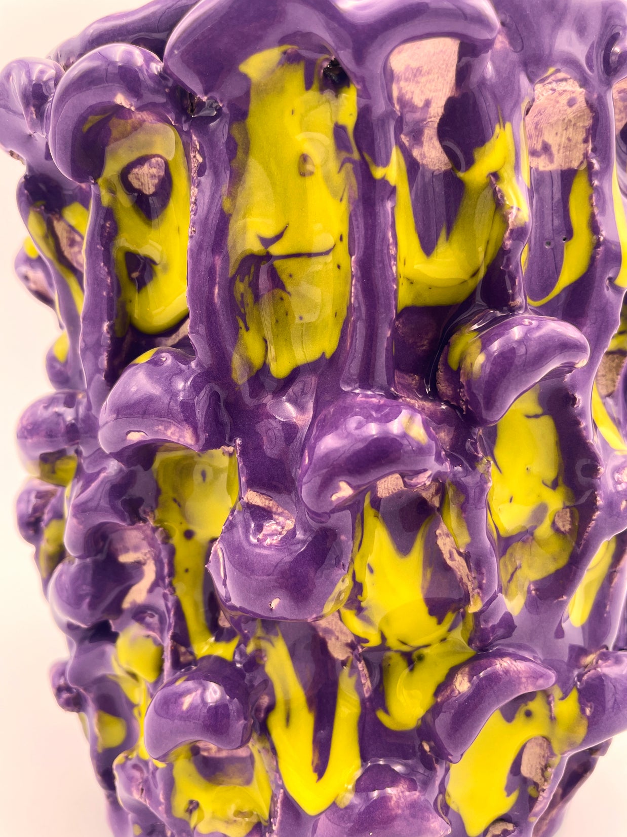 Close-up view of the Ceramic Vase in Velvet Purple and Lemon Yellow, focusing on the interplay of the soft matte purple finish and the dynamic yellow accents on the wavy texture.