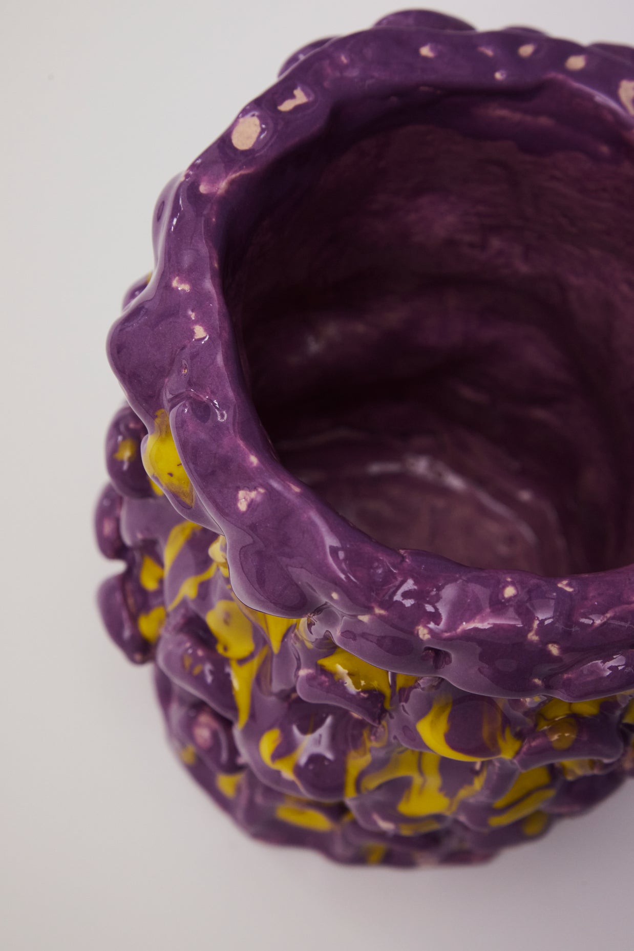 Top view of the Ceramic Vase in Velvet Purple and Lemon Yellow, revealing its deep purple interior, set against a taupe background.