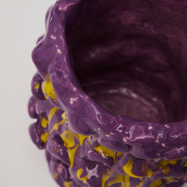 Top view of the Ceramic Vase in Velvet Purple and Lemon Yellow, revealing its deep purple interior, set against a taupe background.