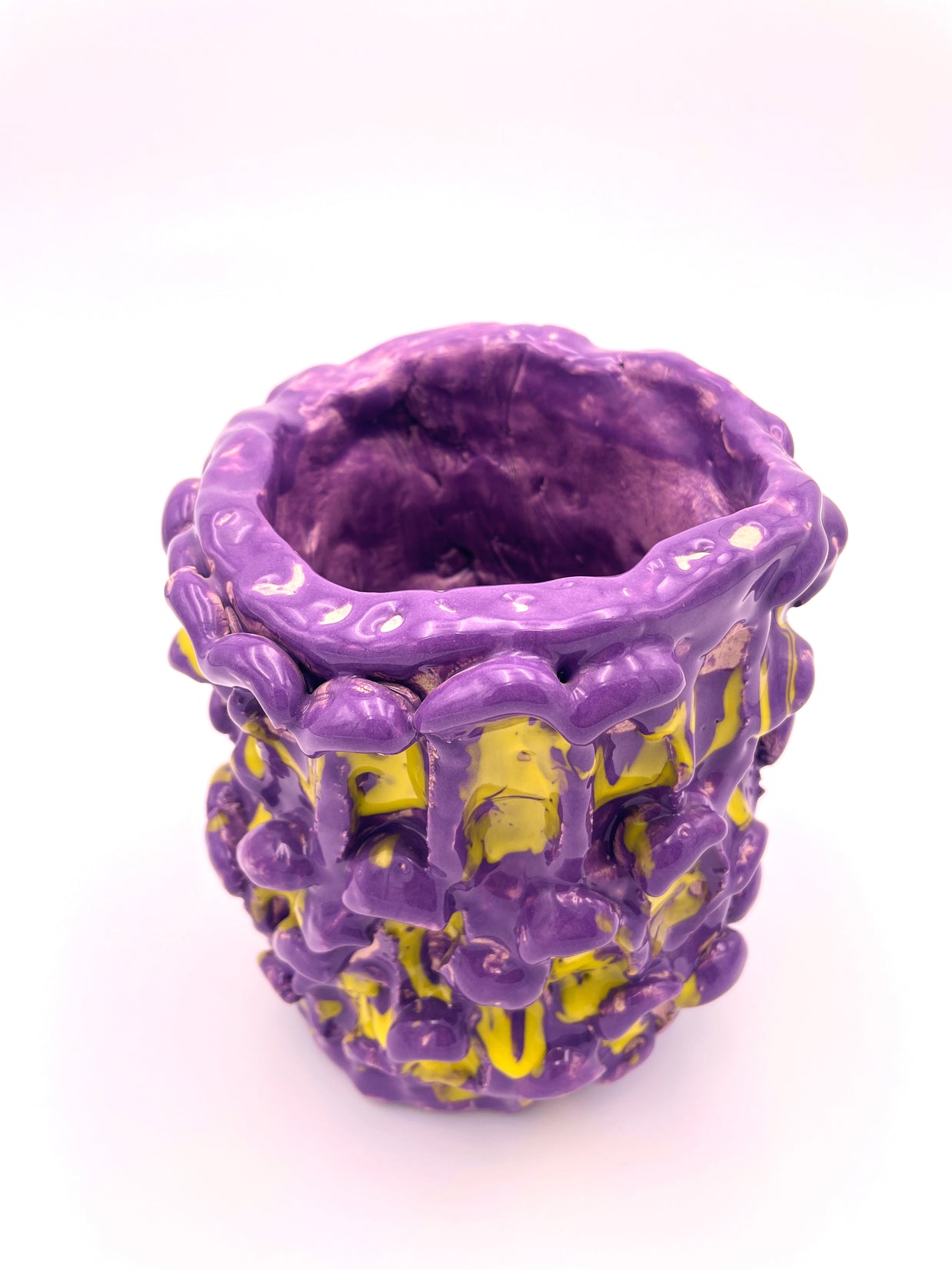 Front view of the Ceramic Vase in Velvet Purple and Lemon Yellow, displayed against a soft pink background for a warm and elegant look.